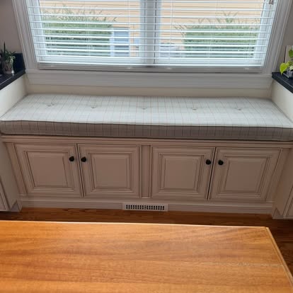 Built-in window seat with tufted cushion