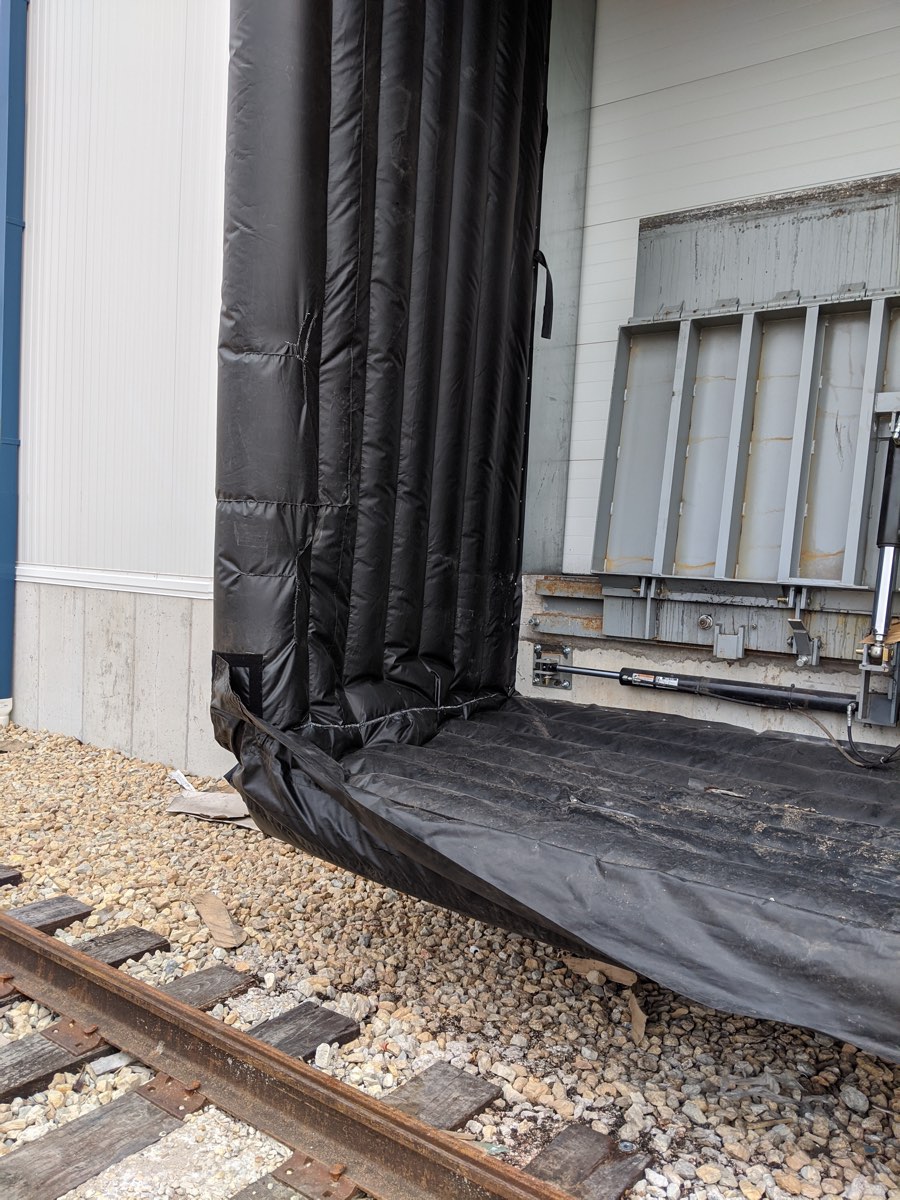 Loading dock seal with a worn, split seam before repair