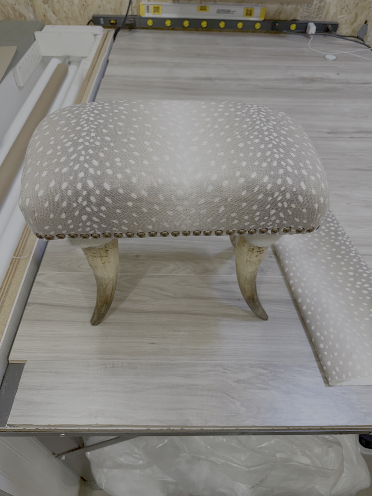 Horn-leg footstool after reupholstery in antelope print