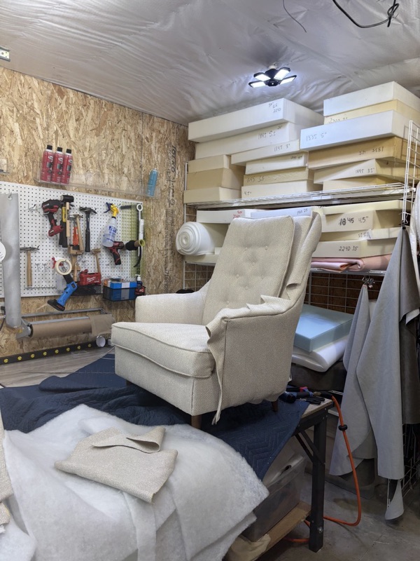 Wingback chair being reupholstered in the workshop