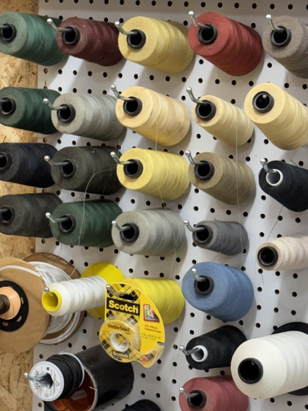 Wall of colorful thread spools in the studio